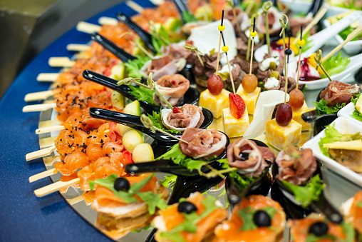 Plate with canapes and snacks, close up.