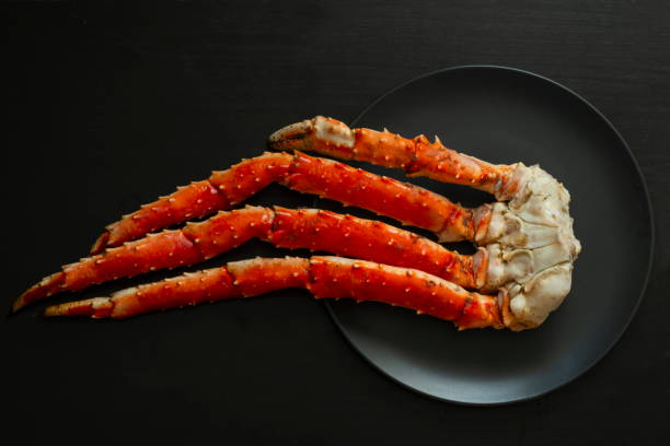 istock Cooked legs of Red King crab, black background. 1227225071