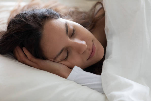 istock Close up serene beautiful woman sleeping under warm blanket alone 1227225909