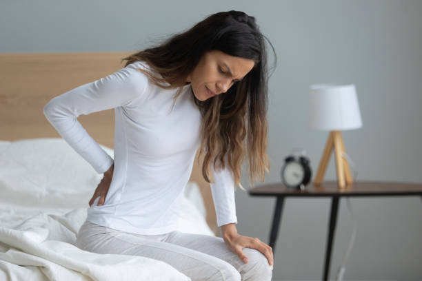 istock Unhappy woman touching stiff muscles, suffering from backache 1227225910