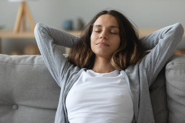 istock Close up serene peaceful girl relaxing on comfortable sofa 1227225942
