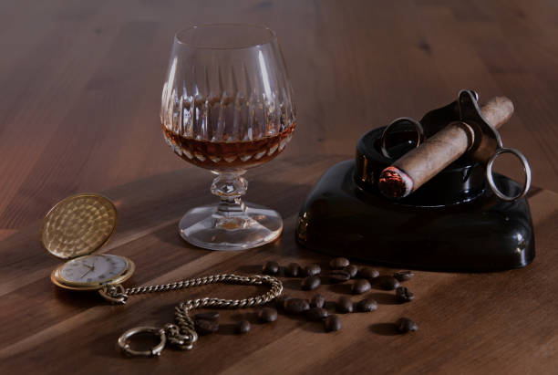Cigar, cognac, gold watch with chain in beautiful still photo. Concept of luxury lifestyle. Cigar, cognac, gold watch with chain in beautiful still photo. Concept of luxury lifestyle. smoking women luxury cigar stock pictures, royalty-free photos & images