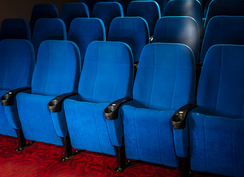 Red chairs in the cinema and theater hall.