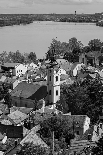 Black and white photo of Orthodox church tower with clock, by the river Danube in Belgrade, Serbia.
