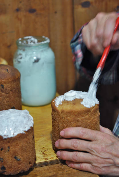 istock senior man frosting russian easter bread, kulich, detail 1227230908
