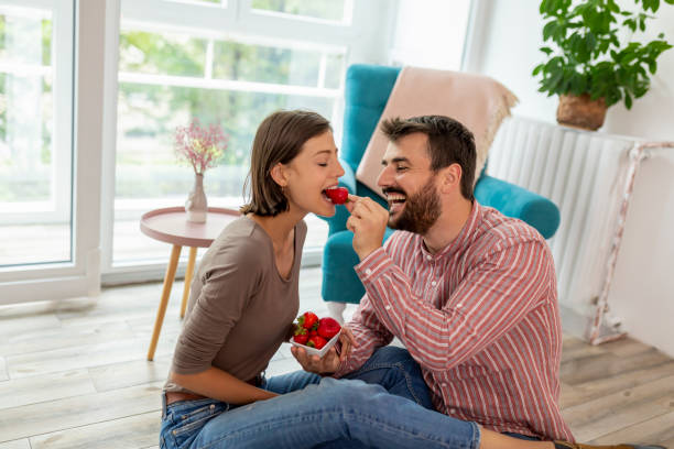 istock Couple eating strawberries and having fun 1227230956