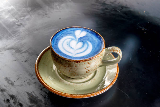 istock Cappuccino coffee in a cup with a blue flower 1227230963