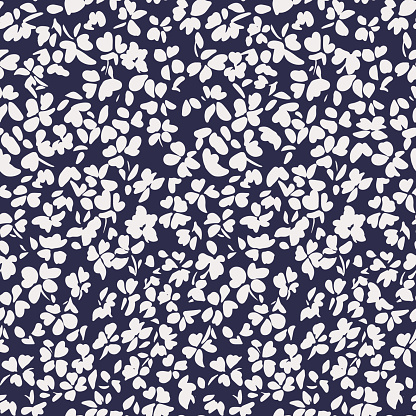 Simple botanical background. Nature ornament. Seamless pattern made of plain flower buds. Glade of small modest daisies. Trendy flat illustration. Fashion, textile and fabric application.
