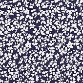 istock Simple botanical background. Nature ornament. Seamless pattern made of plain flower buds. Glade of small modest daisies. Trendy flat illustration. Fashion, textile and fabric application. 1227230981