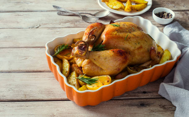 istock Whole chicken grilled with potatoes and lemons 1227233643