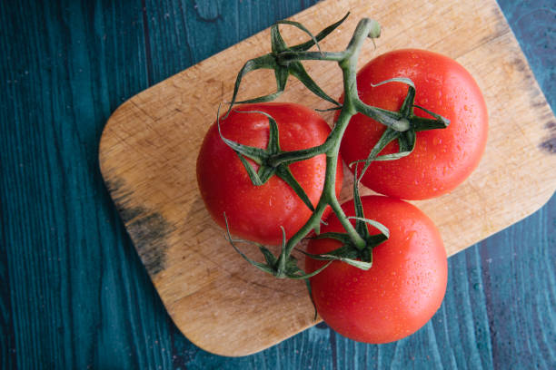 istock Cherry tomatoes on a wooden dark background 1227235010