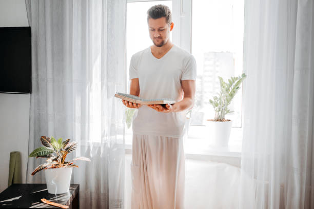 Man holding in hands bed of nails and preparing for morning yoga practice. Man holding in hands bed of nails and preparing for morning yoga practice. Mindfulness and alternative medicine concept. bed of nails stock pictures, royalty-free photos & images