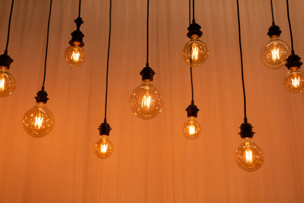 istock Edison light bulb background. Vintage lamps over concrete background. selective focus 1227235601