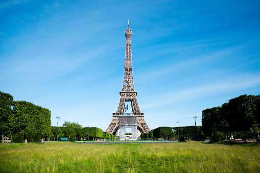 Tour Eiffel is closed and Champ de Mars is empty during pandemic Covid 19 in Europe, without people, without tourists, few days after the Covid19 virus lockdown. Paris in France. May 12, 2020.