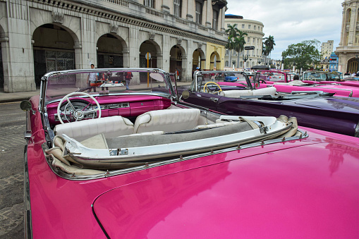 Havana, Cuba - 19th January, 2016: Classic American cabriolet vehicles parked on a street. The old-styled American vehicles from 50s are the ones of the most popular vehicles in Cuba.