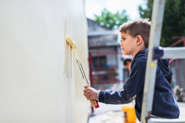 istock Boy helping painting the wall 1227237618