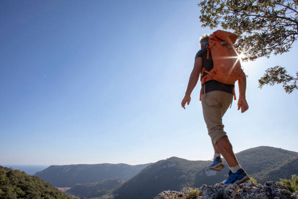 istock Hiker steps forward above the hills in the sunlight 1227237786