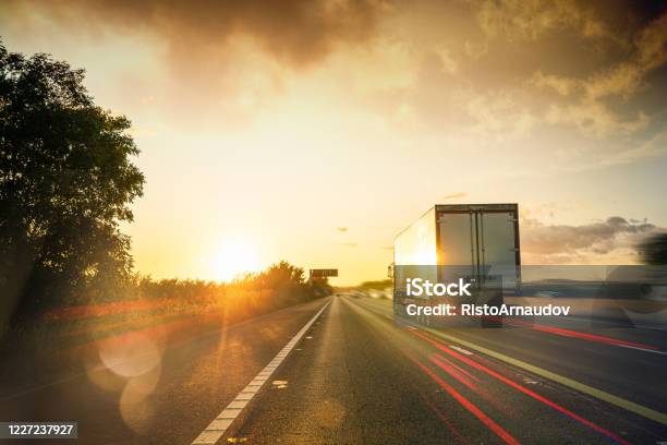 Lorry Traffic Transport On Motorway In Motion Stock Photo - Download Image Now - Delivery Van, Speed, Truck
