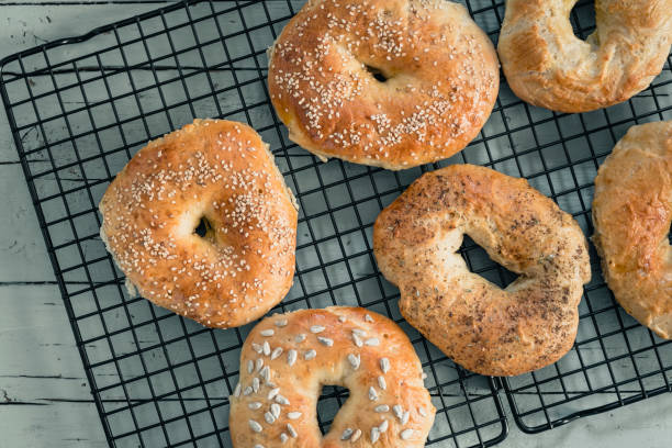 istock Homemade bagels on a cooling rack on grey wood 1227238738