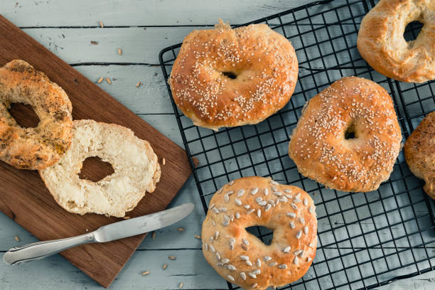 istock Homemade bagels on a cooling rack on grey wood 1227238801