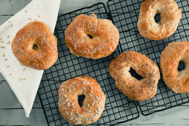 istock Homemade bagels on a cooling rack on grey wood 1227238975