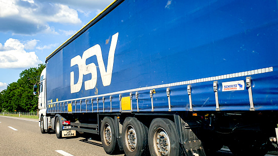 Truck of Danish transport and logistics company DSV Panalpina. Blue Background with white letters, Editorial Content