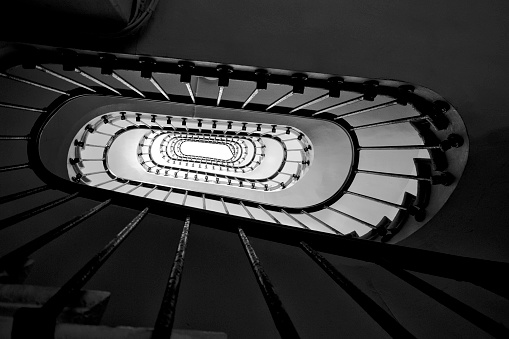 Old-fashioned square shaped spiral staircase- Black and white and low angle shot