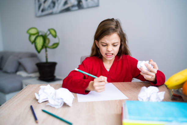 istock Frustrated girl about of homework while she is in home quarantine 1227251132