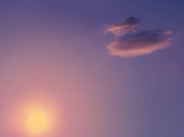 Violet sky at sunset. The sun is in the haze.