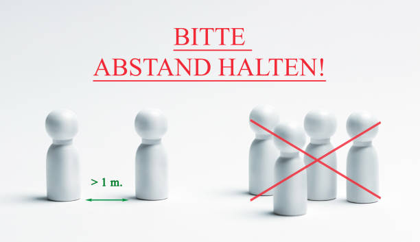 istock Warning sign with german writing - bitte, abstand halten, translation - please, keep your distance. Preventive measures. Social distancing. 1227252595