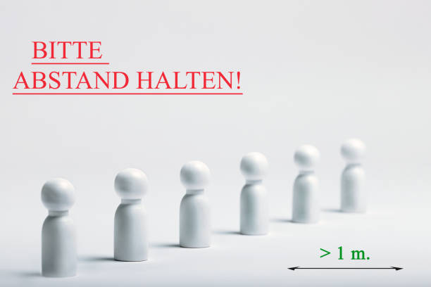 istock Warning sign with german writing - bitte, abstand halten, translation - please, keep your distance. Preventive measures. Social distancing. 1227252612