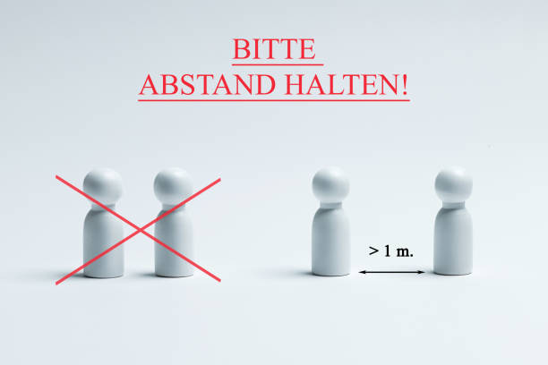 istock Warning sign with german writing - bitte, abstand halten, translation - please, keep your distance. Preventive measures. Social distancing. 1227252620