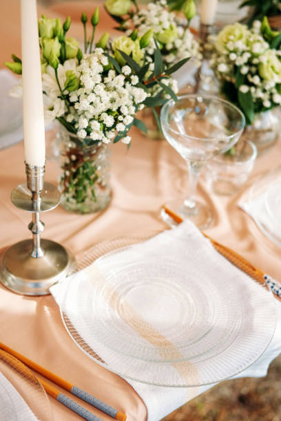 istock Festive table setting for the wedding venue. Peach summer decoration. 1227253430