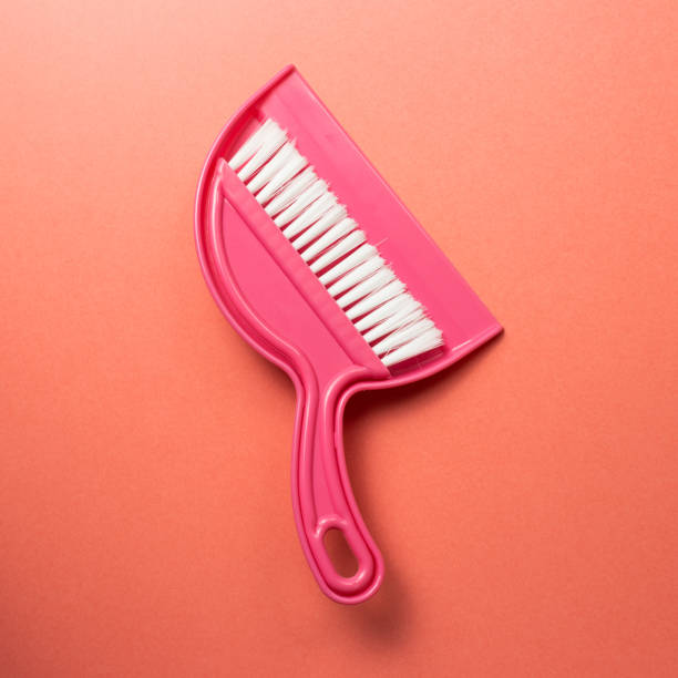 istock Pink broom and dustpan isolated on pink background. top view 1227256600