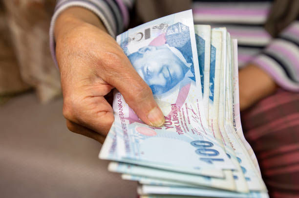 istock old hand with turkish lira. counting Turkish lira 1227258730