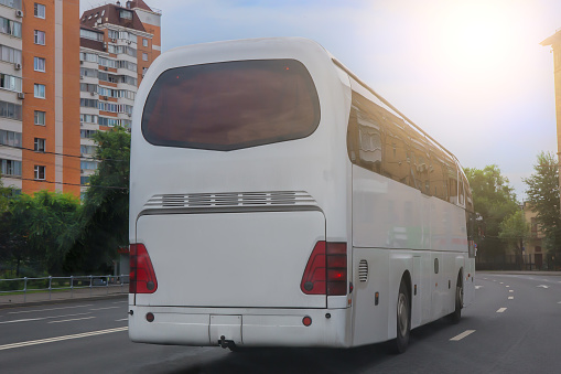 Tourist bus moves along a city street