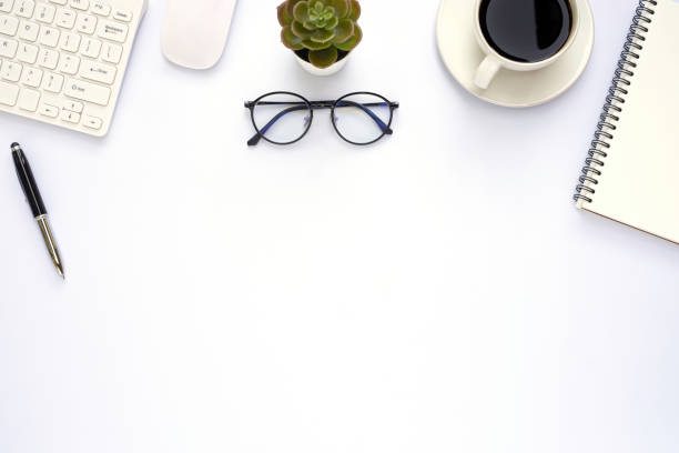 istock Workspace in office with white table. Top view from above of keyboard with notebook and coffee. Desk for modern creative work of designer. Flat lay with blank copy space. Business and finance concept. 1227260225
