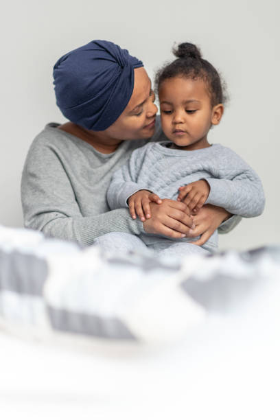 istock A young mom with cancer affectionately plays with her son 1227261203
