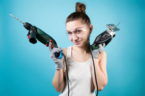 istock Young woman and men's power tools - jigsaw and electric drill 1227261236