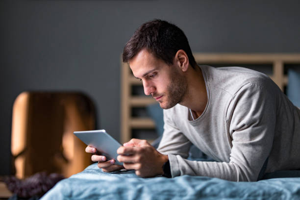 istock Young Handsome Caucasian Man Using a Digital Tablet at Home 1227261773