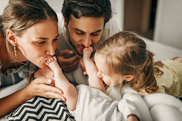 we are cute family - mother baby new kissing imagens e fotografias de stock