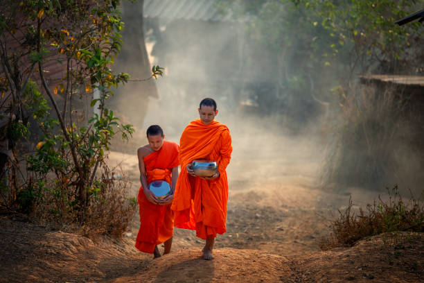 istock Monks and novices issuing alms round. 1227269315