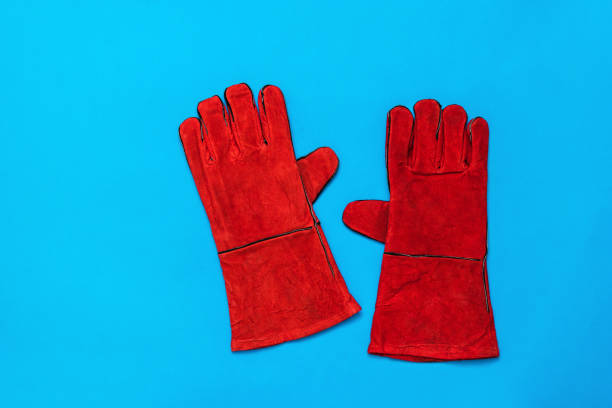 istock A pair of bright welding gloves on a dark blue background. 1227271053