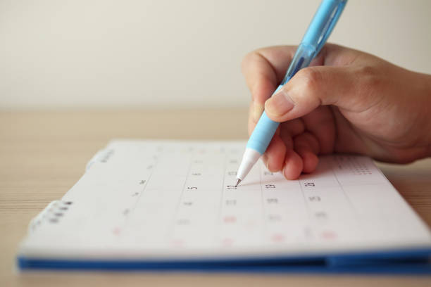 istock Hand with pen writing on calendar date 1227272946