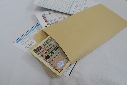 Opened Japanese Passport with Passport Visa isolated on white background.