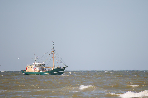 A shrimp cutter in the sun on the North Sea