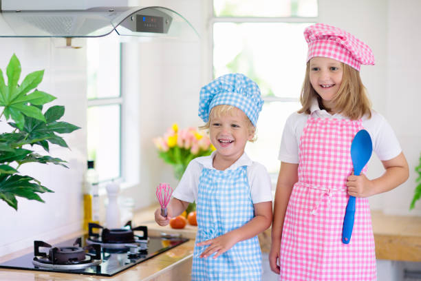 istock Kids cook in white kitchen. Children cooking. 1227284811