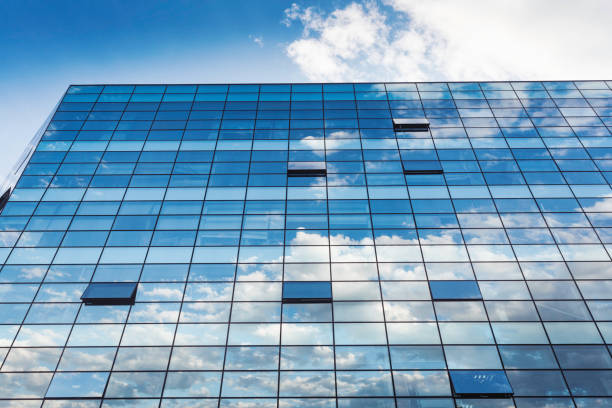 istock City building glass reflecting sky clouds 1227286646
