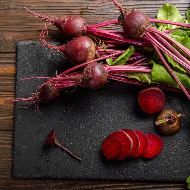 istock Top view at fresh organic beets with leaves on wooden rustic table close up view 1227286798