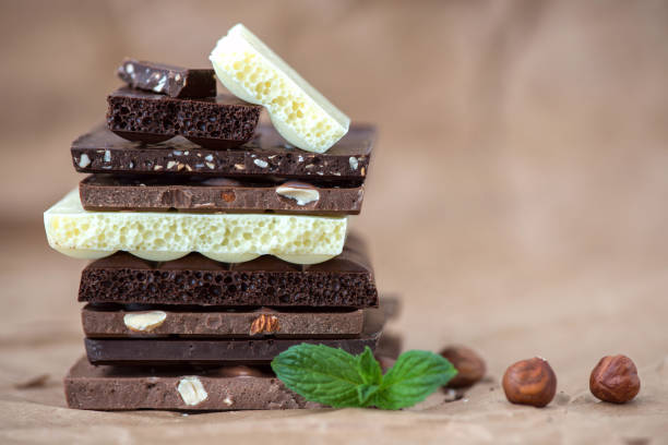 istock Different kinds of chocolates with nuts cocoa powder and mint - selective focus, wrapping brown paper background 1227287827